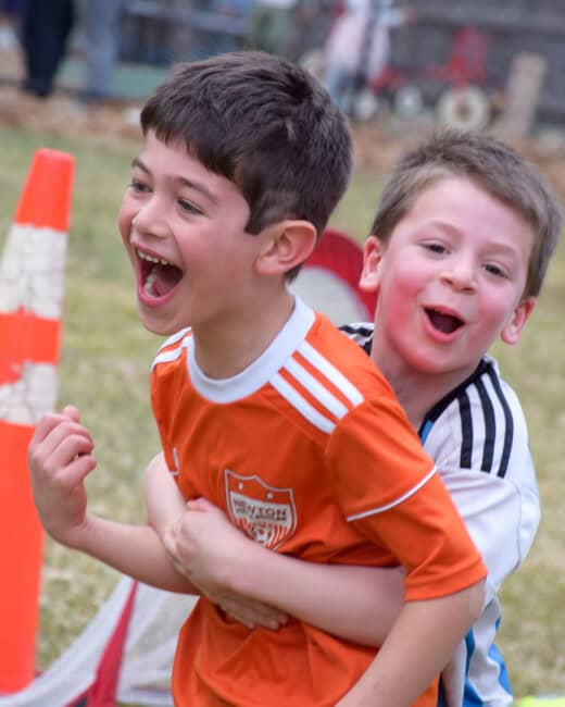 Kids playing soccer at a birthday party.