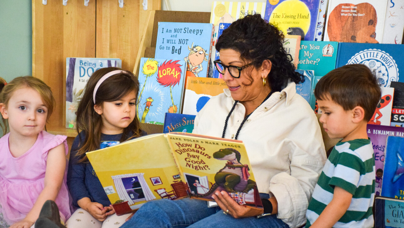 Teacher reading to kids at Hingham Early Learning Center.