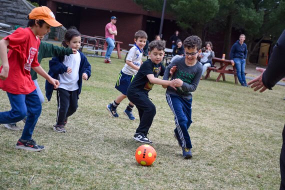 Kids playing soccer at a birthday party.