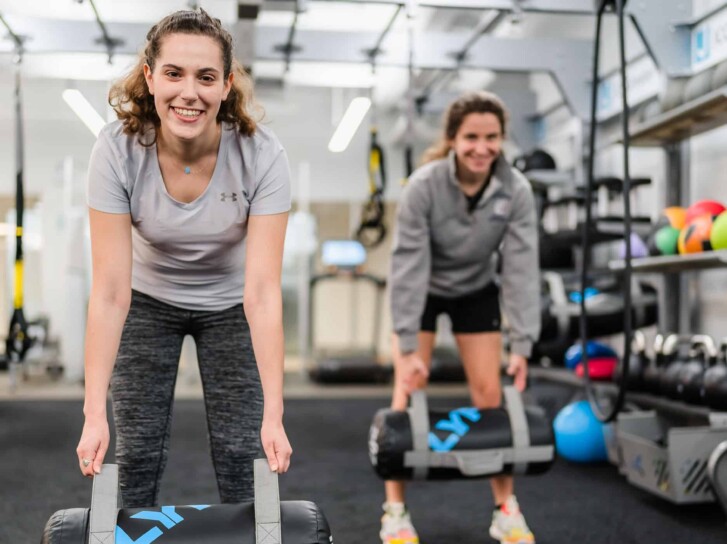 Woman working out with personal trainer at the JCC.