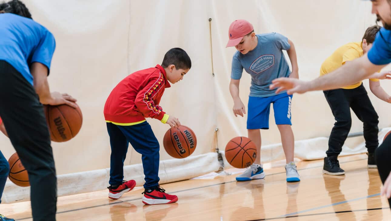 Two boys playing basketball.