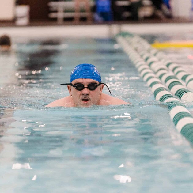 Man swimming laps in a pool.