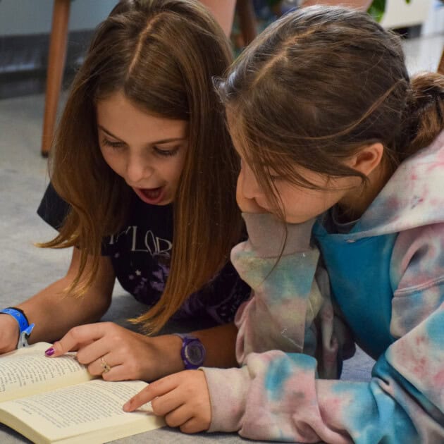 girls reading together.